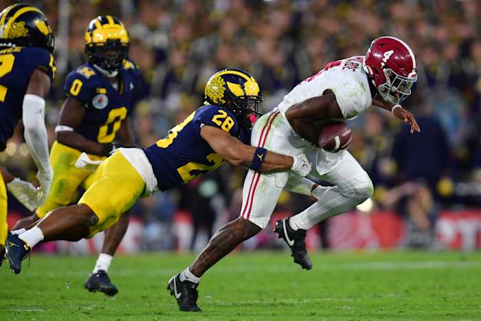 Jan 1, 2024; Pasadena, CA, USA; Michigan Wolverines defensive back Quinten Johnson (28) forces a fumble against Alabama Crimson Tide quarterback Jalen Milroe (4) in the fourth quarter in the 2024 Rose Bowl college football playoff semifinal game at Rose Bowl. Mandatory Credit: Gary A. Vasquez-USA TODAY Sports
